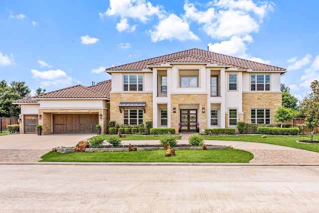 19111 N Frio River Cir, Cypress, TX 77433 - view of front of house with stone siding, french doors, driveway, an attached garage, and stucco siding