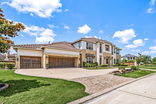 19111 N Frio River Cir, Cypress, TX 77433 - mediterranean / spanish house featuring concrete driveway, an attached garage, stucco siding, stone siding, and a tiled roof