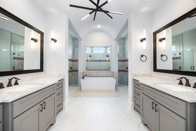 19111 N Frio River Cir, Cypress, TX 77433 - bathroom featuring tiled shower, marble finish floors, a soaking tub, two vanities, and recessed lighting