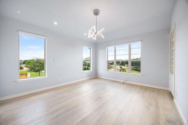 19111 N Frio River Cir, Cypress, TX 77433 - spare room featuring a chandelier, baseboards, light wood-type flooring, and recessed lighting