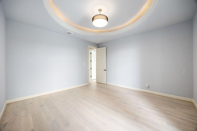 19111 N Frio River Cir, Cypress, TX 77433 - empty room with light wood finished floors, a tray ceiling, and baseboards