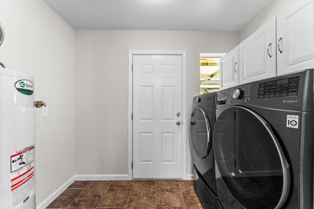 31614 Debbi Ln, Magnolia, TX 77355 - laundry room featuring water heater, washing machine and clothes dryer, cabinet space, and baseboards