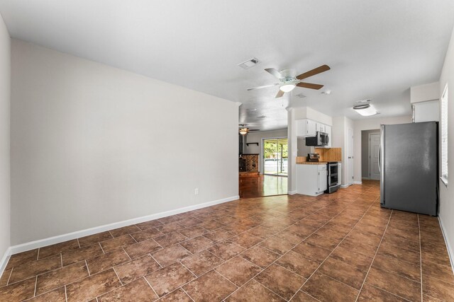 31614 Debbi Ln, Magnolia, TX 77355 - unfurnished living room with a ceiling fan and baseboards