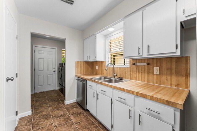 31614 Debbi Ln, Magnolia, TX 77355 - kitchen with a sink, dishwasher, washer and clothes dryer, and white cabinetry