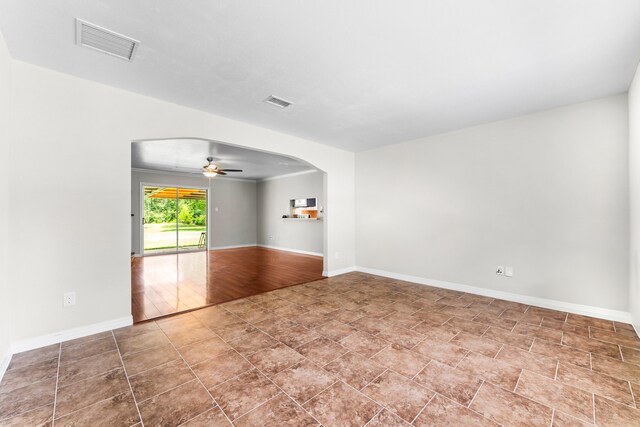 31614 Debbi Ln, Magnolia, TX 77355 - unfurnished room with ceiling fan, baseboards, and arched walkways
