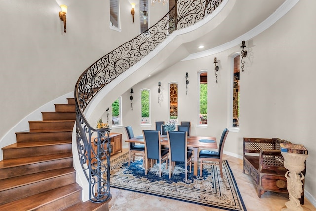 27919 Hansons Ct, Spring, TX 77386 - dining room featuring arched walkways, stairs, a high ceiling, baseboards, and ornamental molding