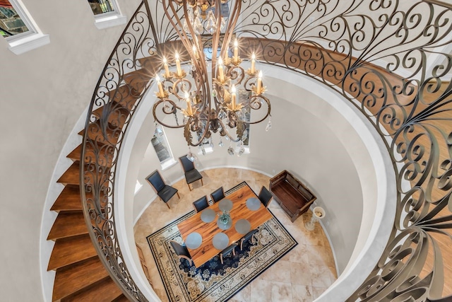 27919 Hansons Ct, Spring, TX 77386 - stairs featuring a chandelier and arched walkways