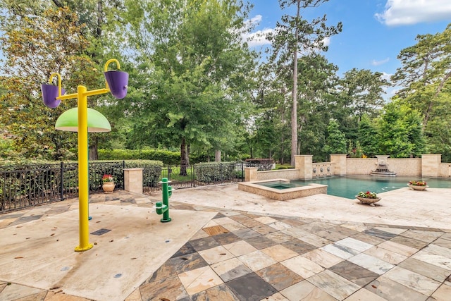 27919 Hansons Ct, Spring, TX 77386 - view of swimming pool with a patio, view of scattered trees, and a pool with connected hot tub