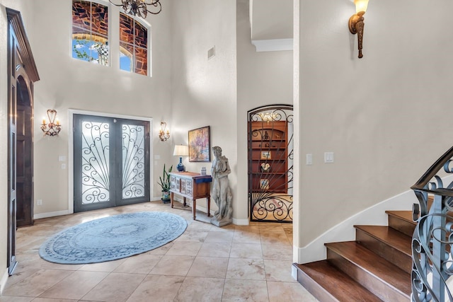 27919 Hansons Ct, Spring, TX 77386 - entrance foyer featuring a high ceiling, french doors, stairs, light tile patterned floors, and baseboards