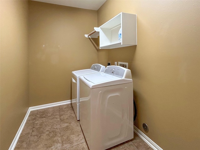 1314 Varese Dr, Pearland, TX 77581 - laundry area with washing machine and clothes dryer, baseboards, and light tile patterned floors