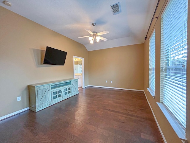 1314 Varese Dr, Pearland, TX 77581 - unfurnished living room with a ceiling fan, dark wood-style floors, plenty of natural light, lofted ceiling, and baseboards
