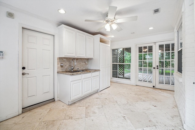 16201 Singapore Ln, Jersey Village, TX 77040 - kitchen with a sink, french doors, white cabinetry, ceiling fan, and ornamental molding