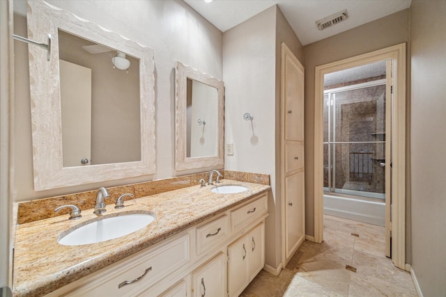 16201 Singapore Ln, Jersey Village, TX 77040 - bathroom featuring double vanity, combined bath / shower with glass door, and baseboards