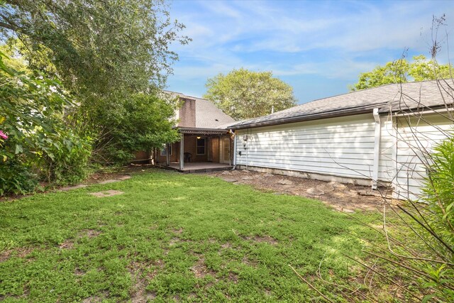 16201 Singapore Ln, Jersey Village, TX 77040 - view of grassy yard featuring a patio area
