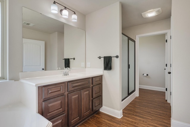 1208 Robinsville Ct, College Station, TX 77845 - full bathroom featuring a stall shower, vanity, wood finished floors, and baseboards