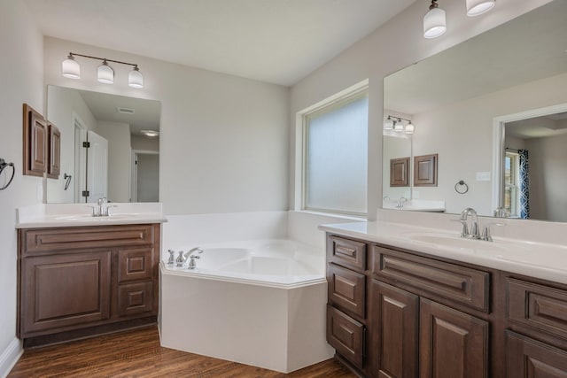 1208 Robinsville Ct, College Station, TX 77845 - full bath with two vanities, wood finished floors, and a garden tub