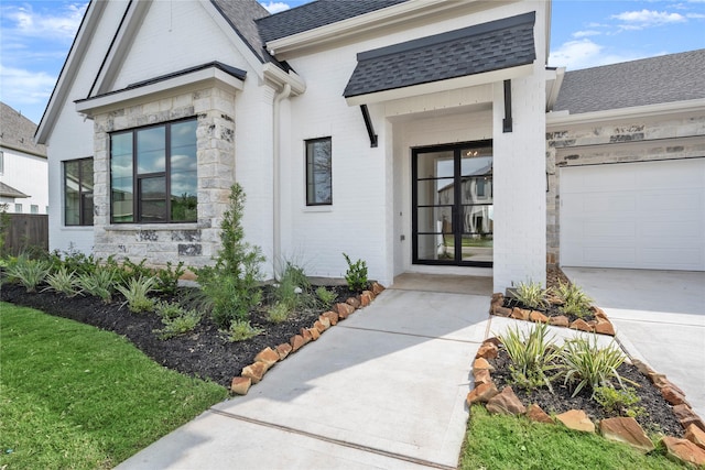 6727 Pine Haven Ct, Katy, TX 77493 - doorway to property with roof with shingles, a garage, stone siding, concrete driveway, and brick siding