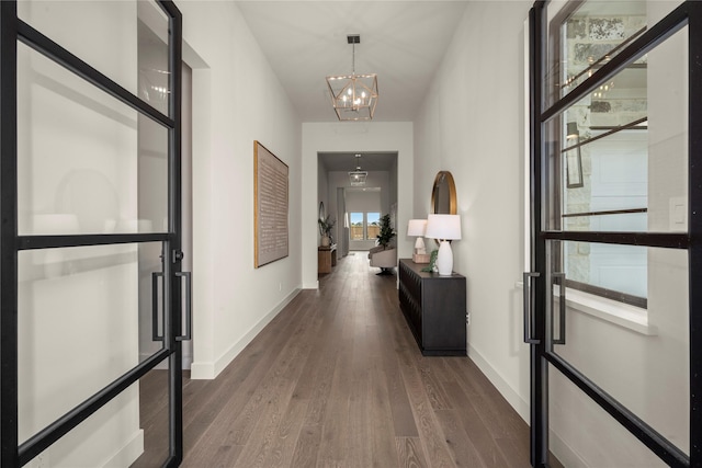 6727 Pine Haven Ct, Katy, TX 77493 - hallway with dark wood-style floors, a chandelier, and baseboards