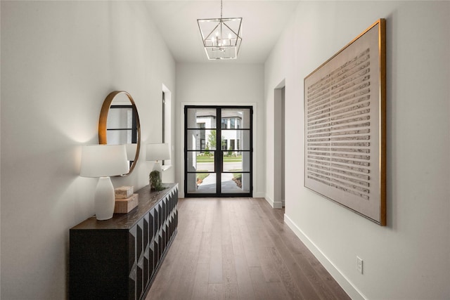 6727 Pine Haven Ct, Katy, TX 77493 - entryway featuring wood finished floors, a chandelier, and baseboards