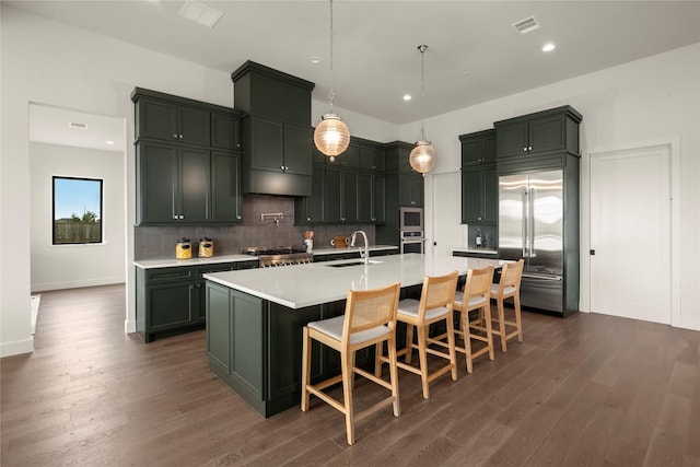 6727 Pine Haven Ct, Katy, TX 77493 - kitchen with stainless steel appliances, a sink, dark wood-style flooring, tasteful backsplash, and recessed lighting
