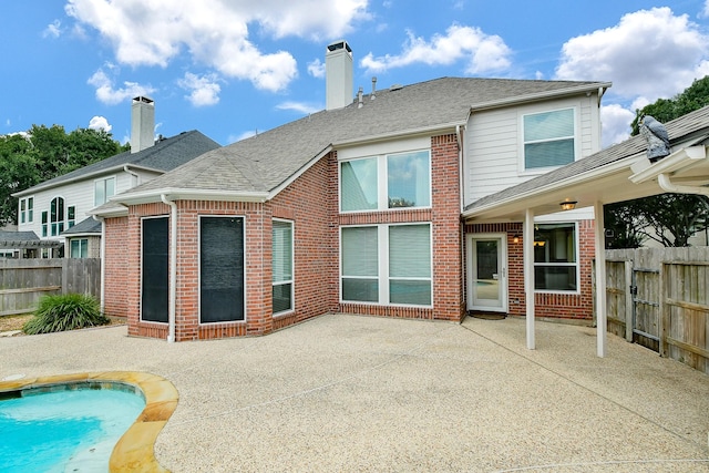 1623 Heddon Falls Dr, Sugar Land, TX 77479 - rear view of house featuring a patio area, brick siding, roof with shingles, and a chimney