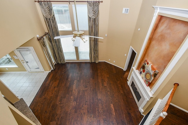 1623 Heddon Falls Dr, Sugar Land, TX 77479 - entrance foyer with a high ceiling, baseboards, wood finished floors, a ceiling fan, and a fireplace