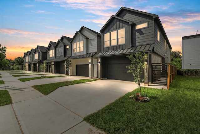 3735 Lydia St, Houston, TX 77021 - view of front facade with a garage, driveway, a standing seam roof, board and batten siding, and a front yard