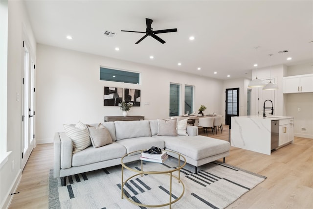3735 Lydia St, Houston, TX 77021 - living room with light wood-style flooring, ceiling fan, recessed lighting, baseboards, and healthy amount of natural light