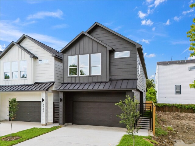 3735 Lydia St, Houston, TX 77021 - view of front of home with an attached garage, board and batten siding, and driveway