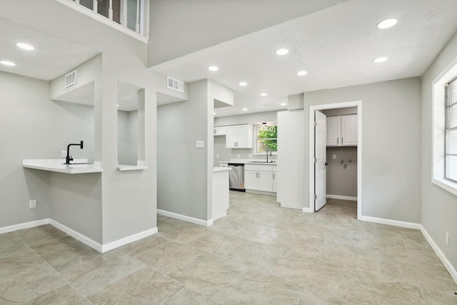10007 Sagedowne Ln, Houston, TX 77089 - kitchen featuring stainless steel dishwasher, a sink, white cabinetry, baseboards, and recessed lighting