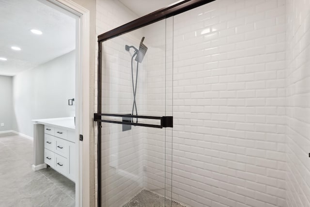 10007 Sagedowne Ln, Houston, TX 77089 - bathroom featuring a shower stall, recessed lighting, vanity, baseboards, and tile patterned flooring