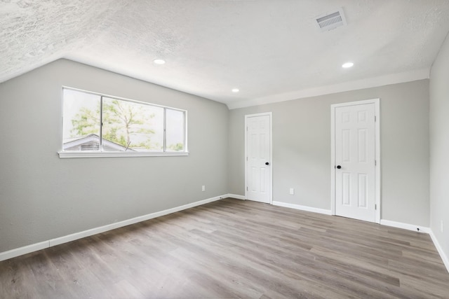10007 Sagedowne Ln, Houston, TX 77089 - unfurnished bedroom with wood finished floors, baseboards, lofted ceiling, recessed lighting, and a textured ceiling
