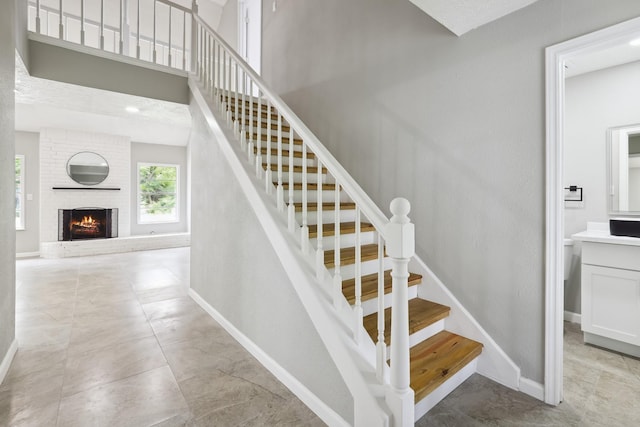 10007 Sagedowne Ln, Houston, TX 77089 - stairway featuring baseboards and a brick fireplace