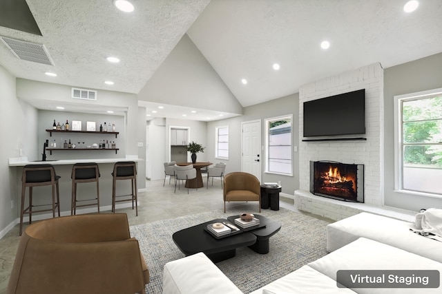 10007 Sagedowne Ln, Houston, TX 77089 - living room with wet bar, a brick fireplace, recessed lighting, baseboards, and vaulted ceiling