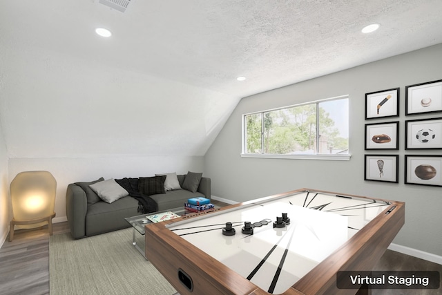 10007 Sagedowne Ln, Houston, TX 77089 - playroom with baseboards, recessed lighting, wood finished floors, vaulted ceiling, and a textured ceiling