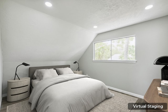 10007 Sagedowne Ln, Houston, TX 77089 - bedroom featuring baseboards, recessed lighting, lofted ceiling, and wood finished floors