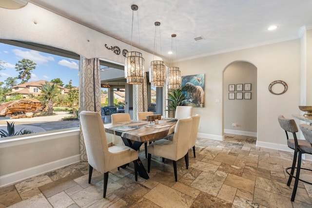 13 Pleasant Shadows Dr, Spring, TX 77389 - dining space with stone tile floors, ornamental molding, arched walkways, baseboards, and recessed lighting