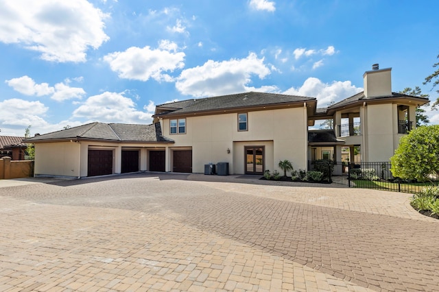 13 Pleasant Shadows Dr, Spring, TX 77389 - view of front of property with french doors, decorative driveway, stucco siding, and a chimney