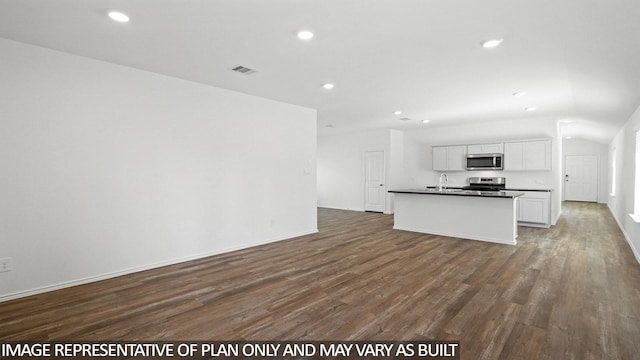 1354 Heather Rosewood Ln, Conroe, TX 77301 - kitchen featuring appliances with stainless steel finishes, a sink, dark wood finished floors, recessed lighting, and dark countertops