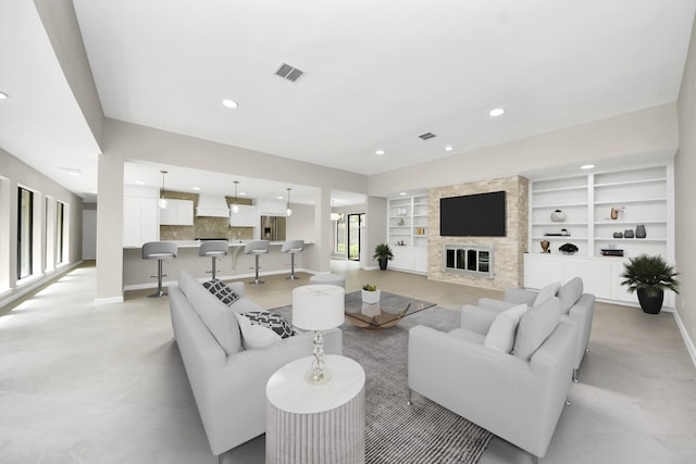 15707 Steamboat Ln, Houston, TX 77079 - living room with built in features, baseboards, recessed lighting, and a stone fireplace
