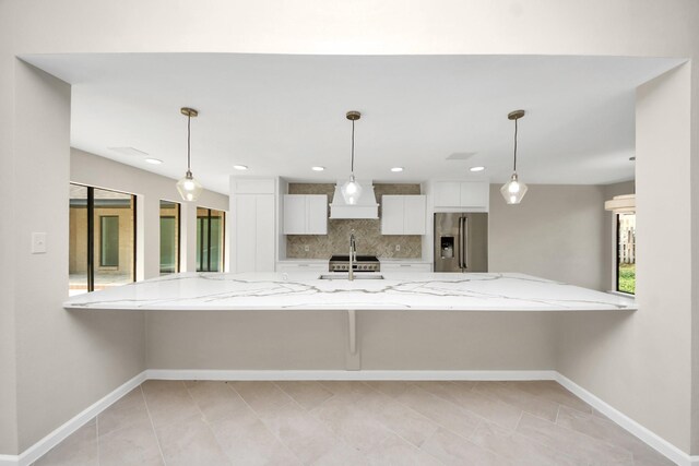 15707 Steamboat Ln, Houston, TX 77079 - kitchen featuring stainless steel refrigerator with ice dispenser, a peninsula, custom exhaust hood, white cabinets, and tasteful backsplash