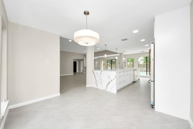 15707 Steamboat Ln, Houston, TX 77079 - kitchen featuring dishwashing machine, recessed lighting, a sink, white cabinetry, and light stone countertops