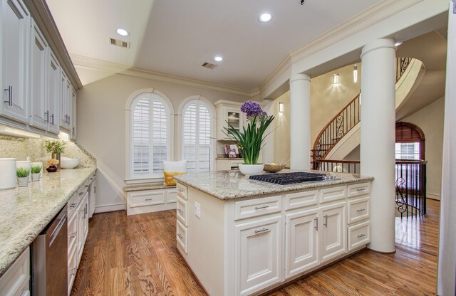 4310 Feagan St Unit A, Houston, TX 77007 - kitchen with appliances with stainless steel finishes, wood finished floors, crown molding, light stone countertops, and white cabinetry