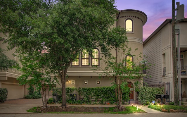 4310 Feagan St Unit A, Houston, TX 77007 - view of front of home featuring stucco siding, a garage, and driveway
