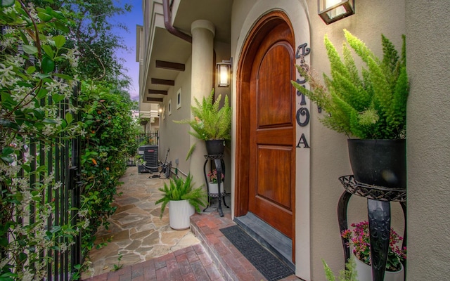 4310 Feagan St Unit A, Houston, TX 77007 - exterior entry at dusk with stucco siding and central AC unit