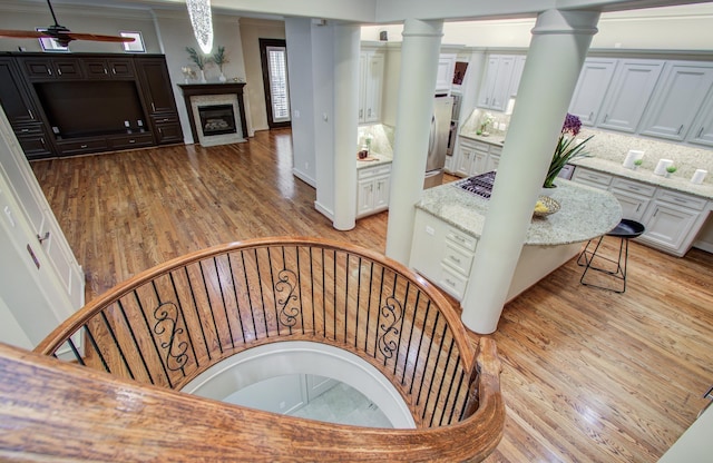 4310 Feagan St Unit A, Houston, TX 77007 - stairway with wood finished floors, a fireplace with flush hearth, ornamental molding, and decorative columns