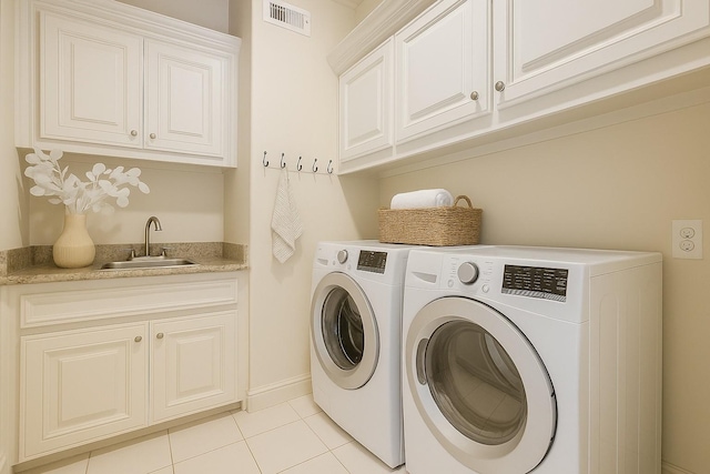 4310 Feagan St Unit A, Houston, TX 77007 - laundry room with cabinet space, separate washer and dryer, light tile patterned flooring, wet bar, and baseboards