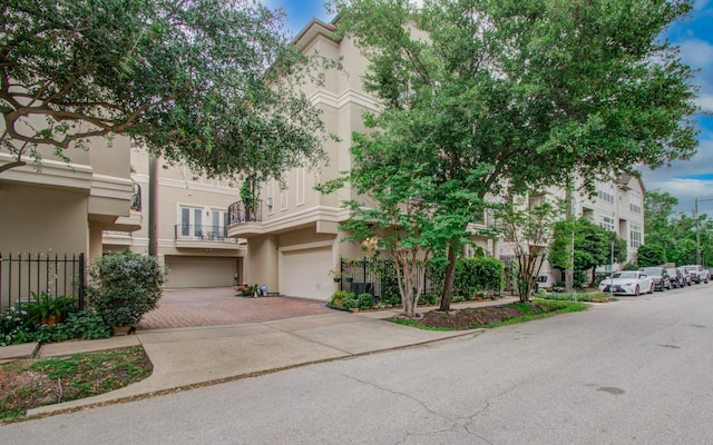 4310 Feagan St Unit A, Houston, TX 77007 - view of property with stucco siding, driveway, and a garage