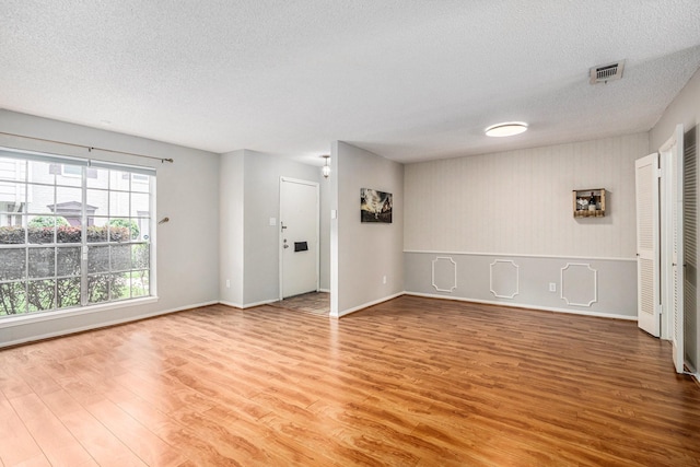 1145 Country Place Dr, Houston, TX 77079 - spare room featuring wood finished floors, a textured ceiling, and baseboards