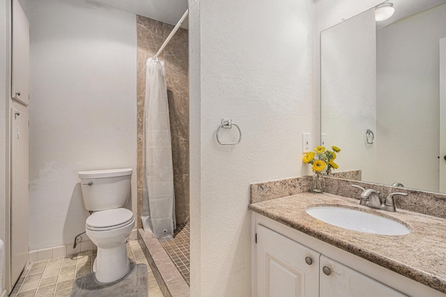1145 Country Place Dr, Houston, TX 77079 - bathroom with toilet, vanity, tiled shower, and baseboards
